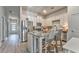 Bright kitchen featuring stainless steel appliances, granite countertops, and a stylish center island with seating at 530 Vandenburg Dr, Villa Rica, GA 30180