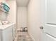 Functional laundry room featuring gray wood flooring, white washer and dryer, and shelving at 530 Vandenburg Dr, Villa Rica, GA 30180