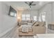 Comfortable living room with modern decor, a large sectional sofa, a ceiling fan, and natural light from a large window at 530 Vandenburg Dr, Villa Rica, GA 30180