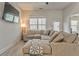 Comfortable living room with modern decor, a large sectional sofa, a ceiling fan, and natural light from a large window at 530 Vandenburg Dr, Villa Rica, GA 30180