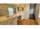 Bathroom with double sinks, large mirror, and tile flooring at 65 Devonshire Dr, Alpharetta, GA 30022