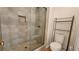 Modern bathroom showcasing a tiled shower with glass door and metal shelving at 65 Devonshire Dr, Alpharetta, GA 30022