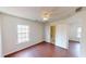 Bright bedroom featuring a ceiling fan, wood-look flooring, a window, and a bathroom at 65 Devonshire Dr, Alpharetta, GA 30022