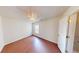 Bright bedroom featuring a ceiling fan, wood-look flooring, a window, and white walls at 65 Devonshire Dr, Alpharetta, GA 30022