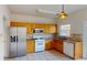 A well-lit kitchen featuring stainless steel appliances, tile countertops, and ample cabinet space at 65 Devonshire Dr, Alpharetta, GA 30022