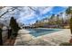 Large community pool covered for the off-season and surrounded by evergreen trees at 65 Devonshire Dr, Alpharetta, GA 30022