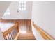 Staircase featuring wooden railings, black balusters, and wood-look flooring at 65 Devonshire Dr, Alpharetta, GA 30022