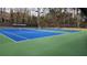 Community tennis courts including nets and benches at 65 Devonshire Dr, Alpharetta, GA 30022