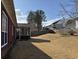 View of large backyard showing dormant grass and the back of the house at 2690 Freemans Walk Dr, Dacula, GA 30019