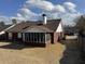 View of the home's backyard featuring a screened-in porch and a well-maintained lawn at 2690 Freemans Walk Dr, Dacula, GA 30019