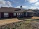 Expansive backyard view of the house, including screened porch and dormant grass at 2690 Freemans Walk Dr, Dacula, GA 30019