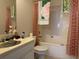 Standard bathroom with white vanity, toilet and shower with patterned shower curtains at 2690 Freemans Walk Dr, Dacula, GA 30019