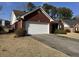 Charming home with a two-car garage and a well-manicured front lawn and landscaping at 2690 Freemans Walk Dr, Dacula, GA 30019