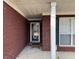 Inviting front entrance with brick surround, complemented by white trim at 2690 Freemans Walk Dr, Dacula, GA 30019