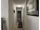 Hallway showcasing neutral walls, and access to a full bathroom at 2690 Freemans Walk Dr, Dacula, GA 30019