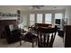 Spacious living room with a cozy fireplace, large windows, and neutral carpeting at 2690 Freemans Walk Dr, Dacula, GA 30019
