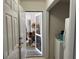 Mud room leading to cluttered storage area with white appliances at 2690 Freemans Walk Dr, Dacula, GA 30019