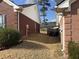 Narrow side yard with short dormant grass and exterior access at 2690 Freemans Walk Dr, Dacula, GA 30019