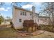 Back exterior view of a house featuring a patio, deck and ample yard space at 4002 Forest Grove Nw Pass, Acworth, GA 30101