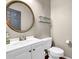Bathroom with a white vanity, mirror, and a toilet with dark wood look flooring at 4002 Forest Grove Nw Pass, Acworth, GA 30101