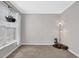 Simple room with light-colored walls, large window with hanging planter, and corner floor lamp at 4002 Forest Grove Nw Pass, Acworth, GA 30101