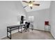 Bedroom/Office featuring light walls, ceiling fan, a window, and a large black desk with computer equipment at 4002 Forest Grove Nw Pass, Acworth, GA 30101