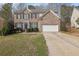 Charming two-story brick home featuring a two-car garage and manicured lawn at 4002 Forest Grove Nw Pass, Acworth, GA 30101