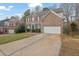 Charming two-story brick home featuring a two-car garage and manicured lawn at 4002 Forest Grove Nw Pass, Acworth, GA 30101