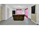 Spacious room with concrete floors, light-colored walls, and a brown sofa at 4002 Forest Grove Nw Pass, Acworth, GA 30101