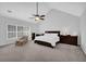 Large main bedroom featuring vaulted ceilings, ceiling fan, neutral color palette, and a large window for natural light at 4002 Forest Grove Nw Pass, Acworth, GA 30101