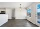 An open dining area with wood-look floors and a glass door leading to the backyard at 74 Brookhaven Way, Rockmart, GA 30153