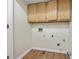 Small laundry room includes washer/dryer hookups and overhead storage cabinets at 3900 Belle Glade Trl, Snellville, GA 30039