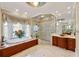 Luxurious bathroom featuring a soaking tub, glass-enclosed shower, and elegant vanity at 4266 Woodland Brook Se Dr, Atlanta, GA 30339