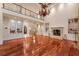 Open-concept living room showcasing hardwood floors, a fireplace, and built-in shelving at 4266 Woodland Brook Se Dr, Atlanta, GA 30339