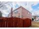 Exterior view of a brick two-story home with a wood fence and grass yard at 480 Glenns Farm Way, Grayson, GA 30017