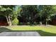 Lush backyard featuring healthy lawn, landscape beds, and a fenced perimeter for privacy at 480 Glenns Farm Way, Grayson, GA 30017