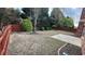 A spacious backyard featuring a wooden fence, greenery, and a concrete patio at 480 Glenns Farm Way, Grayson, GA 30017