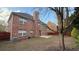View of the rear of the home showing brickwork, and fenced backyard at 480 Glenns Farm Way, Grayson, GA 30017
