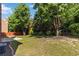 Large, grassy backyard enhanced with mature trees and lush green landscaping at 480 Glenns Farm Way, Grayson, GA 30017