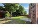 Spacious backyard featuring a concrete patio, lawn, fence, trees, and a well-manicured garden at 480 Glenns Farm Way, Grayson, GA 30017