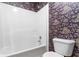 Bathroom featuring a shower-tub combo with a white surround and vintage floral wallpaper at 480 Glenns Farm Way, Grayson, GA 30017
