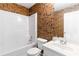 Bathroom featuring a shower-tub combo, leaf-themed wallpaper and a sleek vanity at 480 Glenns Farm Way, Grayson, GA 30017