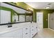 Primary bathroom with dual sinks, a large mirror, and a walk-in shower at 480 Glenns Farm Way, Grayson, GA 30017