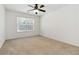Bright bedroom with a ceiling fan and window overlooking the yard at 480 Glenns Farm Way, Grayson, GA 30017
