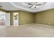 Large bedroom showcasing a tray ceiling and access to the ensuite bathroom with dual sinks at 480 Glenns Farm Way, Grayson, GA 30017