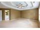 Neutral bedroom showcasing a door to the primary bathroom and large window at 480 Glenns Farm Way, Grayson, GA 30017