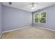 This bedroom features a light blue wall, carpet, and a window providing ample natural light at 480 Glenns Farm Way, Grayson, GA 30017