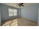 Light blue bedroom featuring a ceiling fan and natural light from a window with blinds at 480 Glenns Farm Way, Grayson, GA 30017
