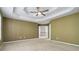 Large bedroom showcasing a tray ceiling and access to the upstairs landing at 480 Glenns Farm Way, Grayson, GA 30017