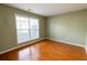 A comfortable bedroom with a hardwood floor and a large window providing plenty of natural light at 480 Glenns Farm Way, Grayson, GA 30017